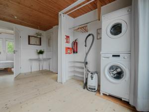a laundry room with a washer and dryer at Holiday Home Taio - 500m from the sea by Interhome in Lakolk
