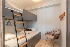 a bedroom with bunk beds with a desk and a chair at Åre Travel-Tottbacken 1 in Åre