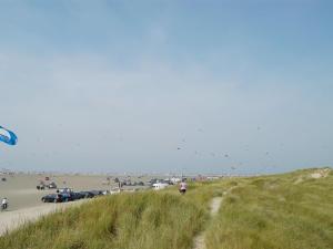 a group of people on a beach flying kites at Holiday Home Solina - 500m from the sea by Interhome in Lakolk