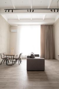 a living room with a couch and a table at REST INN apart hotel in Cherkasy