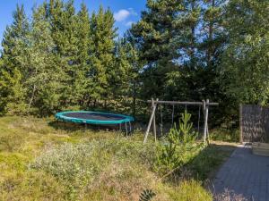 un trampolino vuoto in un cortile con alberi di Holiday Home Silva - 3-9km from the sea by Interhome a Tagholm