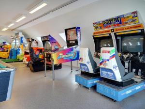 a room with arcade games and video game consoles at Apartment Maylin - 2-3km from the sea by Interhome in Sønderby