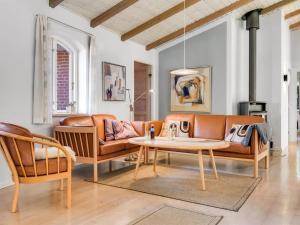 a living room with a couch and a table at Holiday Home Agusta - 1-1km from the sea by Interhome in Mølby +20 photos