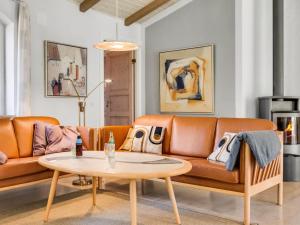 a living room with a couch and a table at Holiday Home Agusta - 1-1km from the sea by Interhome in Mølby