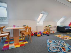 a room with a table and chairs and a playroom at Apartment Ameli - 2-3km from the sea by Interhome in Sønderby