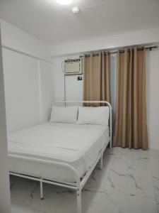 a hospital bed in a hospital room with curtains at Camella Northpoint in Davao City