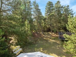 a backyard with a picnic table and trees at Holiday Home Benedikta - 2-4km from the sea by Interhome in Vesterhede