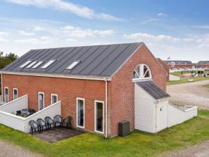 a red brick building with solar panels on its roof at Apartment Aldora - 2-3km from the sea by Interhome in Sønderby