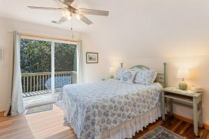 Un dormitorio con una cama y una ventana grande. en 5049 - Carolyn's Getaway, en Kill Devil Hills