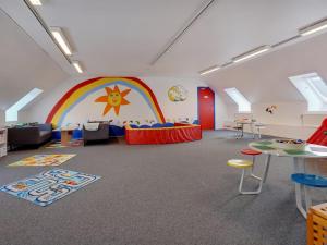 a room with a rainbow and a table and chairs at Apartment Mirija - 2-3km from the sea by Interhome in Havneby