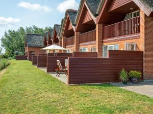 a house with a wooden fence in front of it at Holiday Home Henrietta - 3-5km from the sea by Interhome in Kongsmark