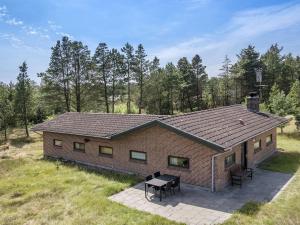 a house with a picnic table in front of it at Holiday Home Stojanka - 1km from the sea by Interhome in Mølby