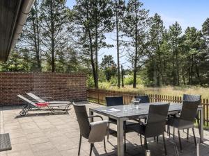 a patio with a table and chairs and a bench at Holiday Home Stojanka - 1km from the sea by Interhome in Mølby