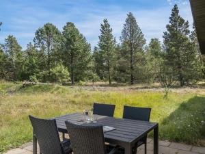 a table and chairs on a patio with a view of a field at Holiday Home Stojanka - 1km from the sea by Interhome in Mølby