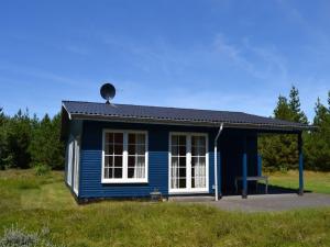 a blue house with a white window at Holiday Home Redward - 1km from the sea by Interhome in Mølby