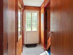 an empty hallway with a door and a window at Holiday Home Redward - 1km from the sea by Interhome in Mølby +14 photos