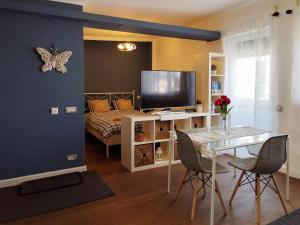 a living room with a table and a bed at Amo Bucharest in Bucharest