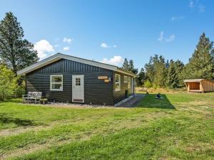 a tiny house in a field with a yard at Holiday Home Bogatin - 1km from the sea by Interhome in Mølby +22 photos