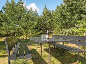 a picnic table with a bottle of wine on it at Holiday Home Bogatin - 1km from the sea by Interhome in Mølby