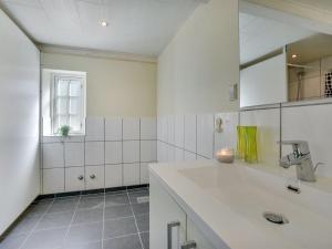 a white kitchen with a sink and a window at Holiday Home Gudmund - 3-9km from the sea by Interhome in Kongsmark +28 photos