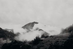 a black and white photo of a mountain with clouds at Tiny House Casa de Lili in Seix