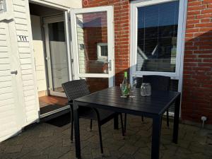 a black table and chairs on a patio at Apartment Bosse - 2-3km from the sea by Interhome in Sønderby