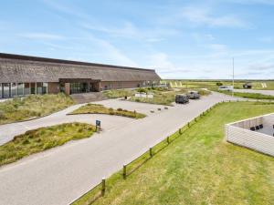 an aerial view of a building with cars parked on a road at Apartment Bosse - 2-3km from the sea by Interhome in Sønderby +24 photos