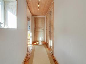a hallway with a wooden ceiling and a white rug at Holiday Home Brigida - 500m from the sea by Interhome in Lakolk