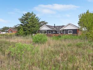 a house in a field of tall grass at Holiday Home Brigida - 500m from the sea by Interhome in Lakolk