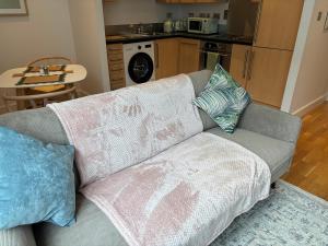 a couch with pillows on it in a living room at 10 Popeshead in York