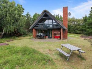 a house with a picnic table in front of it at Holiday Home Anna - 1km from the sea by Interhome in Vesterhede