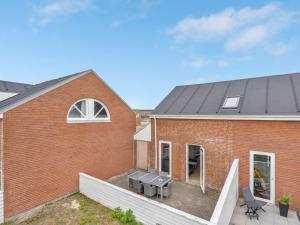 a red brick house with a black roof at Apartment Anke - 500m from the sea by Interhome in Sønderby