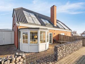 a house with a conservatory on the side of it at Holiday Home Harriette - 100m from the sea by Interhome in Havneby