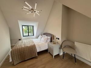 a bedroom with a bed and a ceiling fan at Fire Station View-Central-2 king beds-Brand new interior in Topsham