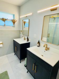 a bathroom with two sinks and a mirror at Sunset Shores in Lake Clarke Shores
