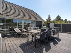 a patio with a table and chairs on a deck at Holiday Home Madalena - 2-8km from the sea by Interhome in Toftum