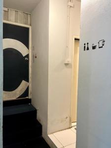 a hallway with a door and stairs in a room at The PARK Society in Chiang Mai +57 photos