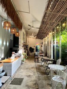 a restaurant with tables and chairs and tables and windows at The PARK Society in Chiang Mai