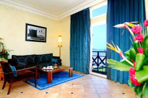 a living room with a couch and a table at Le Médina Essaouira Thalassa Sea & Spa - MGallery Collection in Essaouira