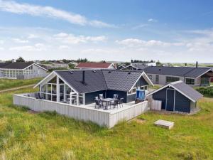 a modular home with a deck and a house at Holiday Home Betti - 200m from the sea by Interhome in Lakolk