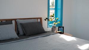 a bedroom with a bed and a vase with flowers at MayHome Binh Dinh in An Hòa