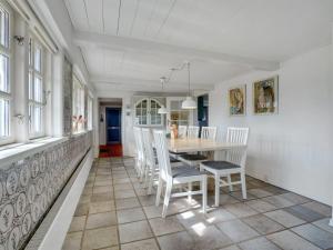a dining room with a table and chairs at Holiday Home Edelgard - 4-5km from the sea by Interhome in Kongsmark