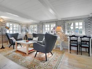 a living room with a couch and chairs and a table at Holiday Home Edelgard - 4-5km from the sea by Interhome in Kongsmark