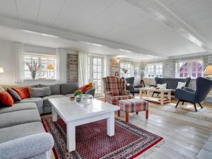 a living room with a couch and a table at Holiday Home Edelgard - 4-5km from the sea by Interhome in Kongsmark