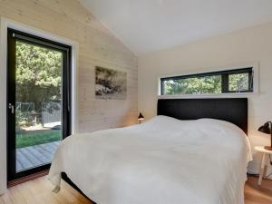 a bedroom with a white bed and a large window at Holiday Home Tea - 2-7km from the sea by Interhome in Bolilmark +41 photos