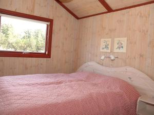 a bedroom with a bed and a window at Holiday Home Harmke - 1km from the sea by Interhome in Vejers Strand