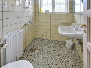 a bathroom with a sink and a toilet at Holiday Home Lioba - 400m from the sea by Interhome in Vejers Strand +18 photos