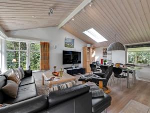 a living room with a couch and a table at Holiday Home Andresine - 900m from the sea by Interhome in Vejers Strand