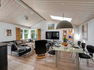 a dining room and living room with a table and chairs at Holiday Home Andresine - 900m from the sea by Interhome in Vejers Strand