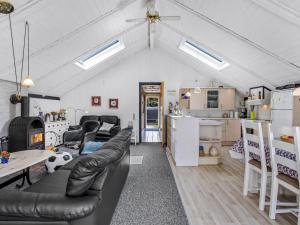 a living room with a couch and a table at Holiday Home Solvejk - 800m from the sea by Interhome in Vejers Strand
